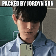 a young man is taking a picture of himself with a meme that says packed by jordyn son