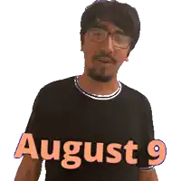a man wearing glasses and a black shirt with the words august 9 on it