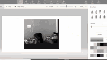 a black and white photo of a person laying on a bed is being edited in a program