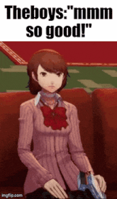 a girl in a pink sweater is sitting on a couch with a gun in her hand .
