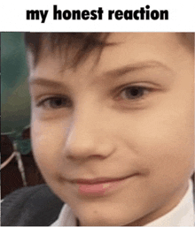 a close up of a young boy 's face with the words `` my honest reaction '' written above him .