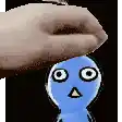a person is holding a blue cartoon character over their head