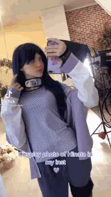 a girl taking a selfie in a cosplay costume