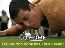 a man is laying on his stomach on a golf course with a golf ball .