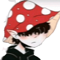 a boy is wearing a red mushroom hat with white polka dots .