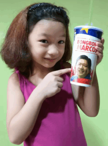 a young girl points to a bongboa marcos cup