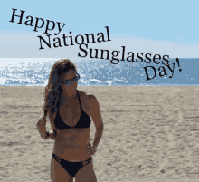 a woman in a bikini stands on a beach with the words " happy national sunglasses day " above her