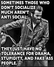 a man with a beard is riding a motorcycle and has a quote on it .