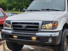 a white truck with a toyota logo on the grille