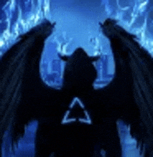 a silhouette of a demon with wings and horns standing in front of a blue background .