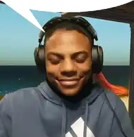 a young man wearing headphones and a blue adidas hoodie smiles