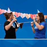 two women wearing afas software shirts celebrate