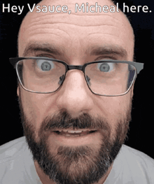 a man with glasses and a beard has the words hey vsauce micheal here on his face