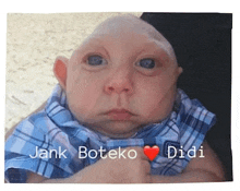 a baby with a very small head is being held by a person and has the name jank boteko didi written on it .