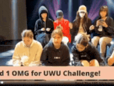 a group of people are sitting in front of a sign that says " omg for uwu challenge "