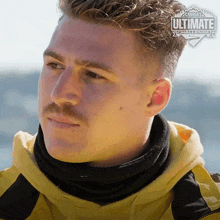 a man with a mustache is wearing a canada 's ultimate challenge sweatshirt