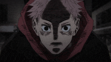 a close up of a person 's face with a red hood