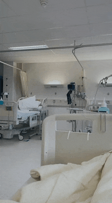 a hospital room with a bed and a bottle of hand sanitizer