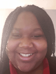 a close up of a woman 's face with braids