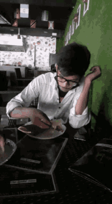 a man sitting at a table with a plate of food in front of him and a menu that says ' chicken '