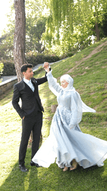 a man and woman are dancing in the grass