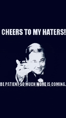 a man in a tuxedo is pointing at the camera with the words cheers to my haters be patient so much more is coming