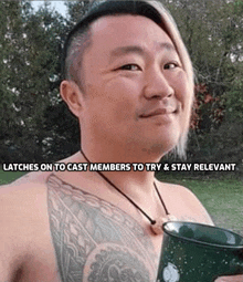 a shirtless man with a tattoo on his chest is holding a coffee mug .