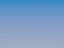 a cartoon character is flying through the air with a wing behind him