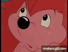 a close up of a cartoon hedgehog 's face on make a gif .