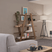 a living room with a ladder shelf and a lamp