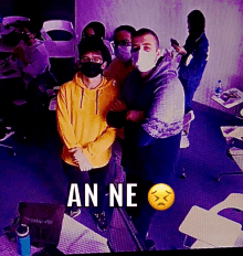 a group of people wearing face masks with an emoji that says an-ne on it