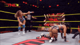 two women are wrestling in a ring with a pna logo