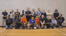 a group of people posing for a picture with one man wearing a red shirt that says " champions "