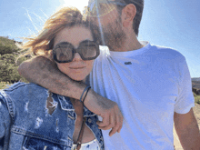 a man wearing a karl lagerfeld shirt kisses a woman