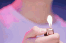 a close up of a person holding a lighter that says thailand