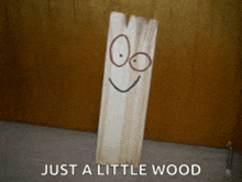 a piece of wood with a face drawn on it