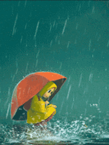 a little girl in a yellow raincoat holding an orange umbrella in the rain