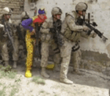 a group of soldiers standing next to a clown in a clown costume