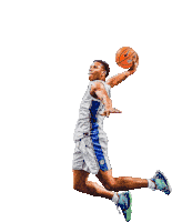 a basketball player is jumping in the air while holding an orange ball