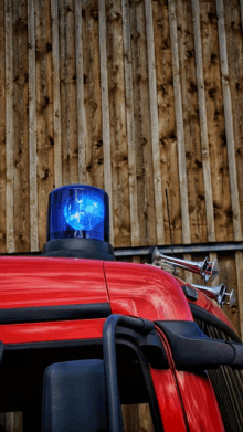 a red truck with a blue light on top of it