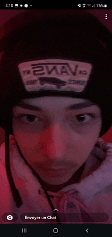 a man wearing a black beanie with the word ewav on it