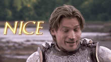 a man in armor is smiling in front of a nice sign