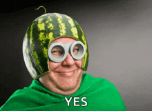 a man wearing a watermelon hat and goggles with the word yes on the bottom