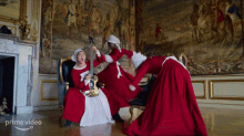 a group of women in red dresses are playing instruments in a room with the words prime video on the bottom left