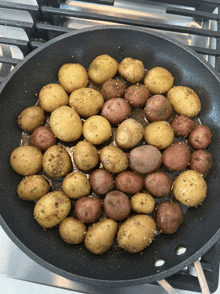 potatoes are cooking in a pan on a stove