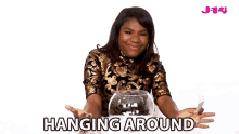 a woman is sitting at a table with a bowl of fish and the words " hanging around " behind her