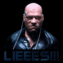 a bald man wearing ear buds with the word lieees on the bottom right