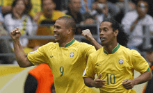 two soccer players wearing yellow jerseys with the number 9 and 10