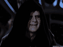 a man in a hooded robe is smiling with memeful.com in the corner