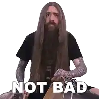 a man with long hair and a beard is holding a drum with the words not bad written below him